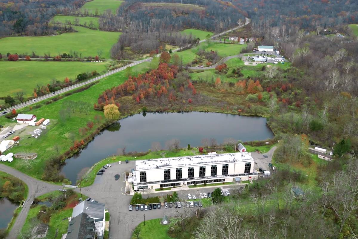 Aerial view of a care center beside a lake in autumn